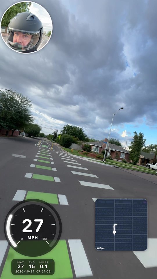 SpeedCam recording a ride down a green bike lane with the gauge, map, and selfie on screen